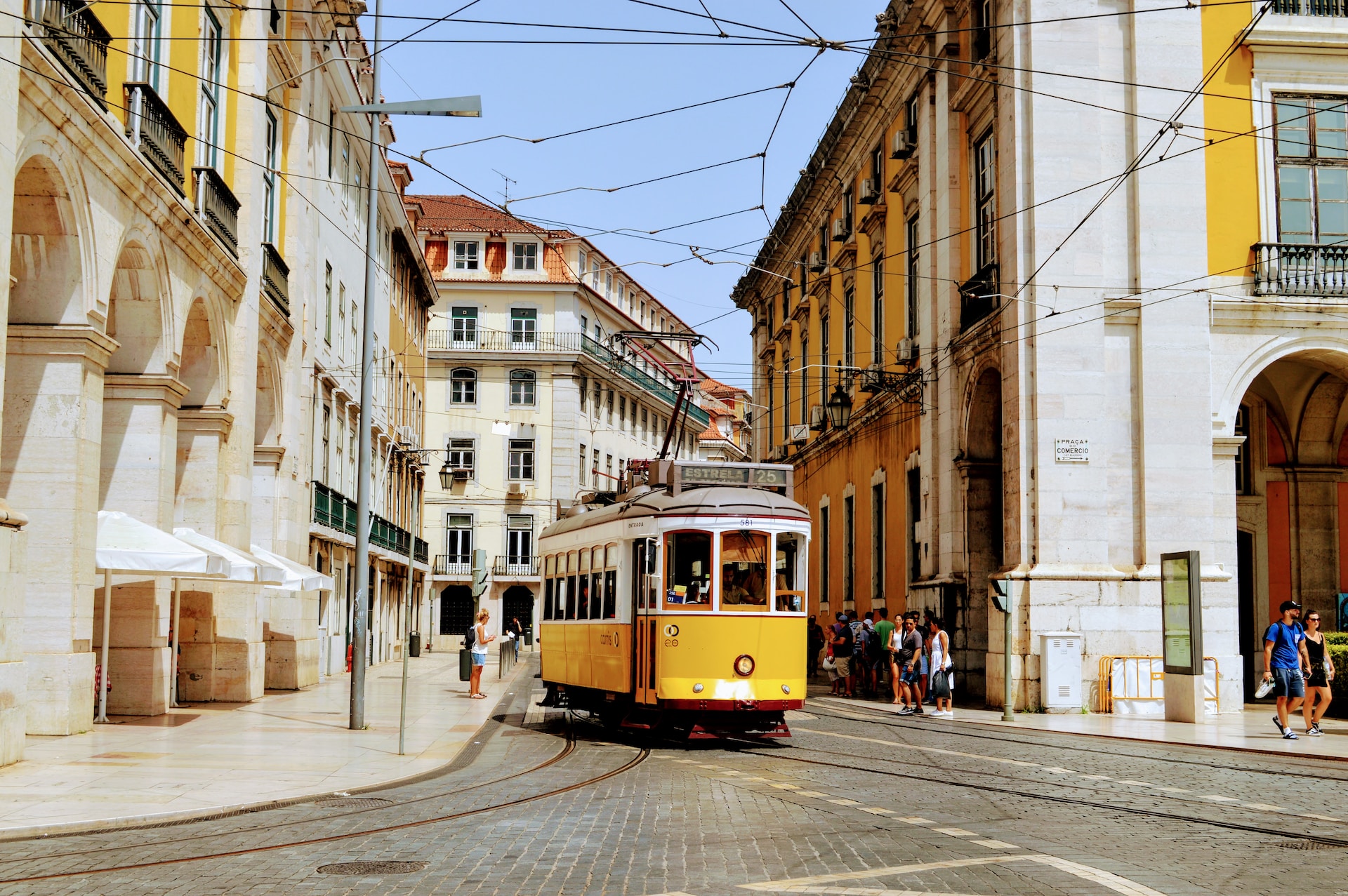 Image of yellow street car to convey how to take Lisbon transportation - Odyssey App