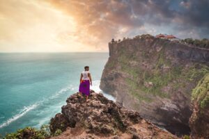 Image of man standing on Uluwatu Temple - odysssey app