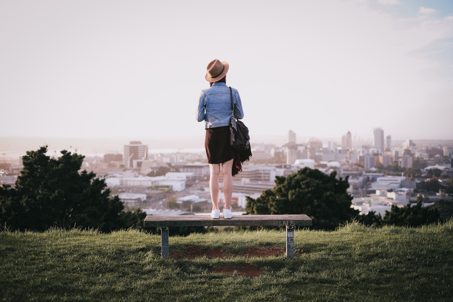 Image of a woman overlooking Aukland New Zealand from a hill- Odyssey App